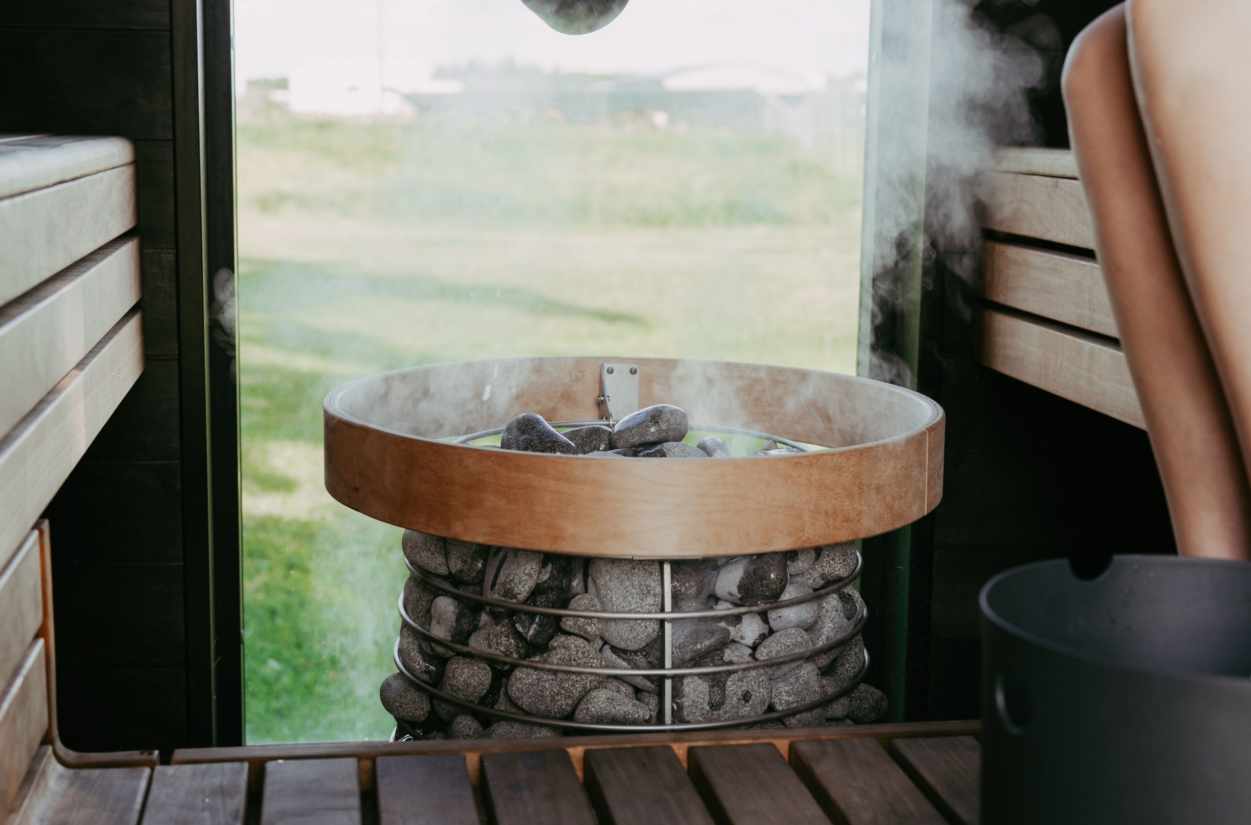 Sauna design avec pierres chauffantes et bancs bois